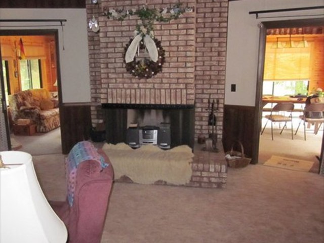 LIVING / DINING ROOM AREA FIREPLACE WITH ENTRANCES TO THE FAMILY ROOM IN THE BACKGROUND