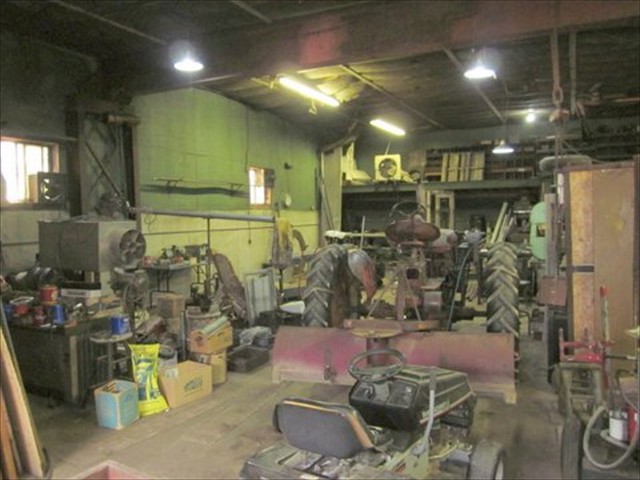 INTERIOR OF WORKSHOP SHOWING STEEL BEAMS AND INSULATION
